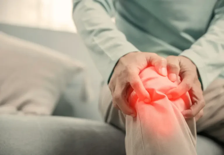 Middle-aged man holding his knee.