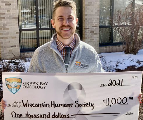Dr. Alex Coffman with donation check